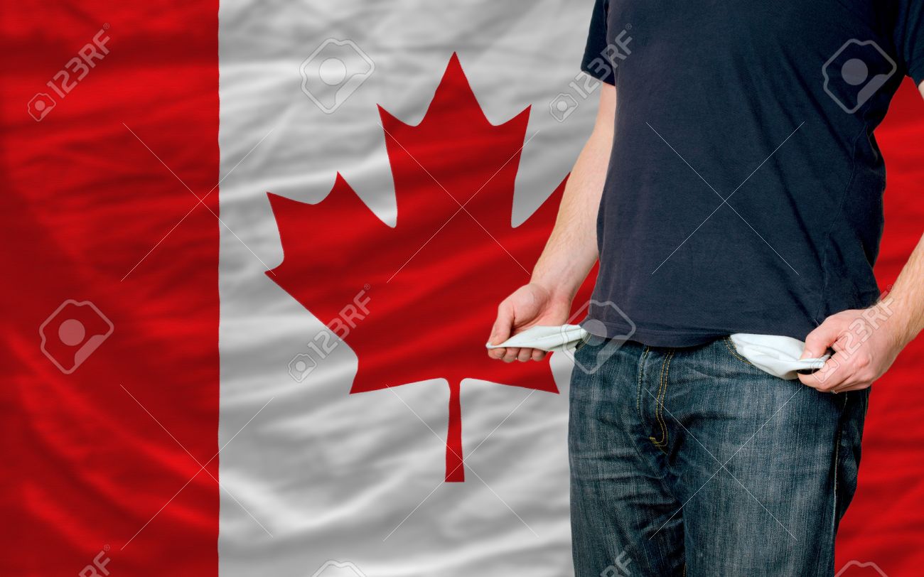 12071094-poor-man-showing-empty-pockets-in-front-of-canada-flag-Stock-Photo