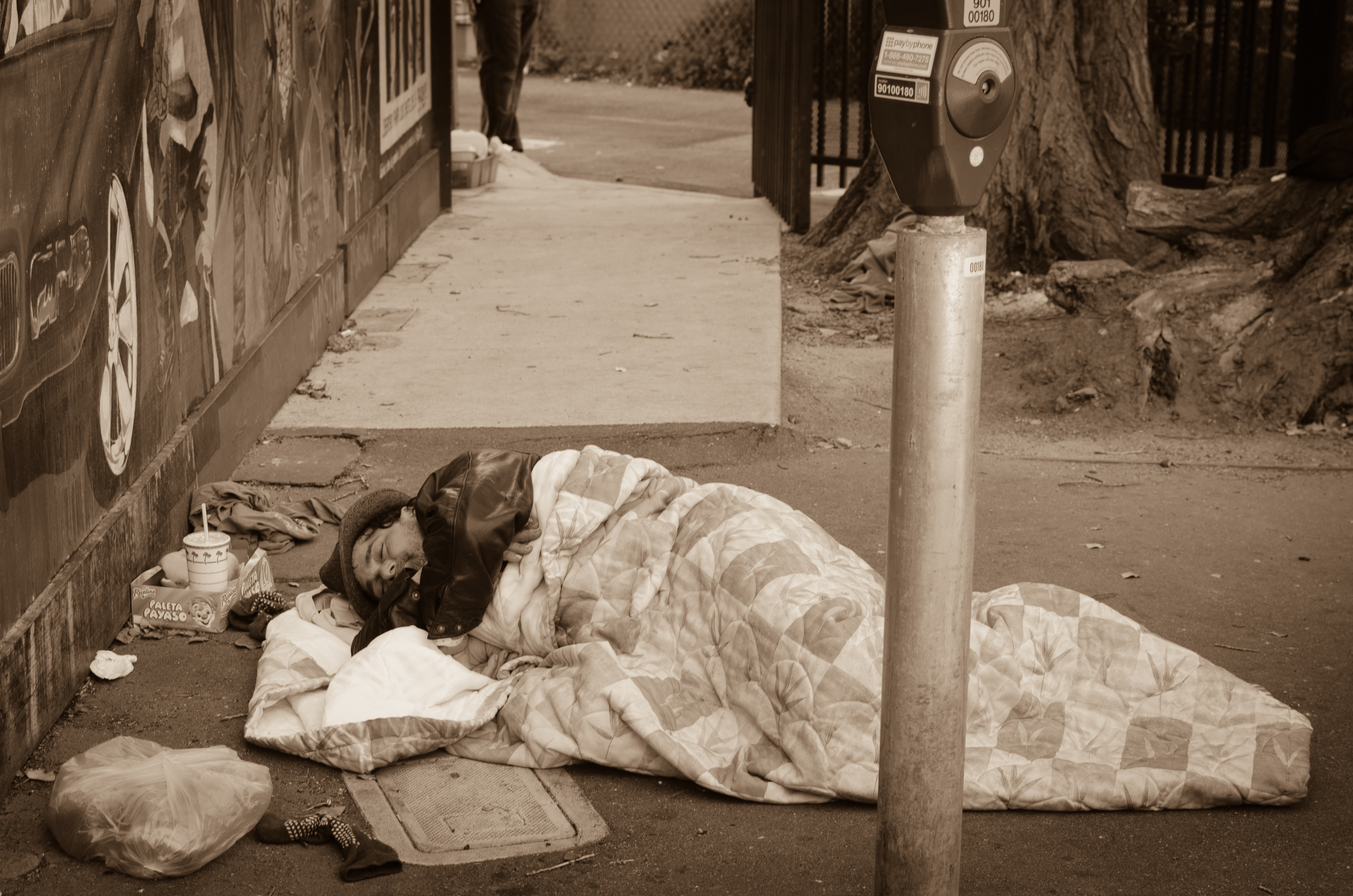 homeless-man-sleeping in a parking lot